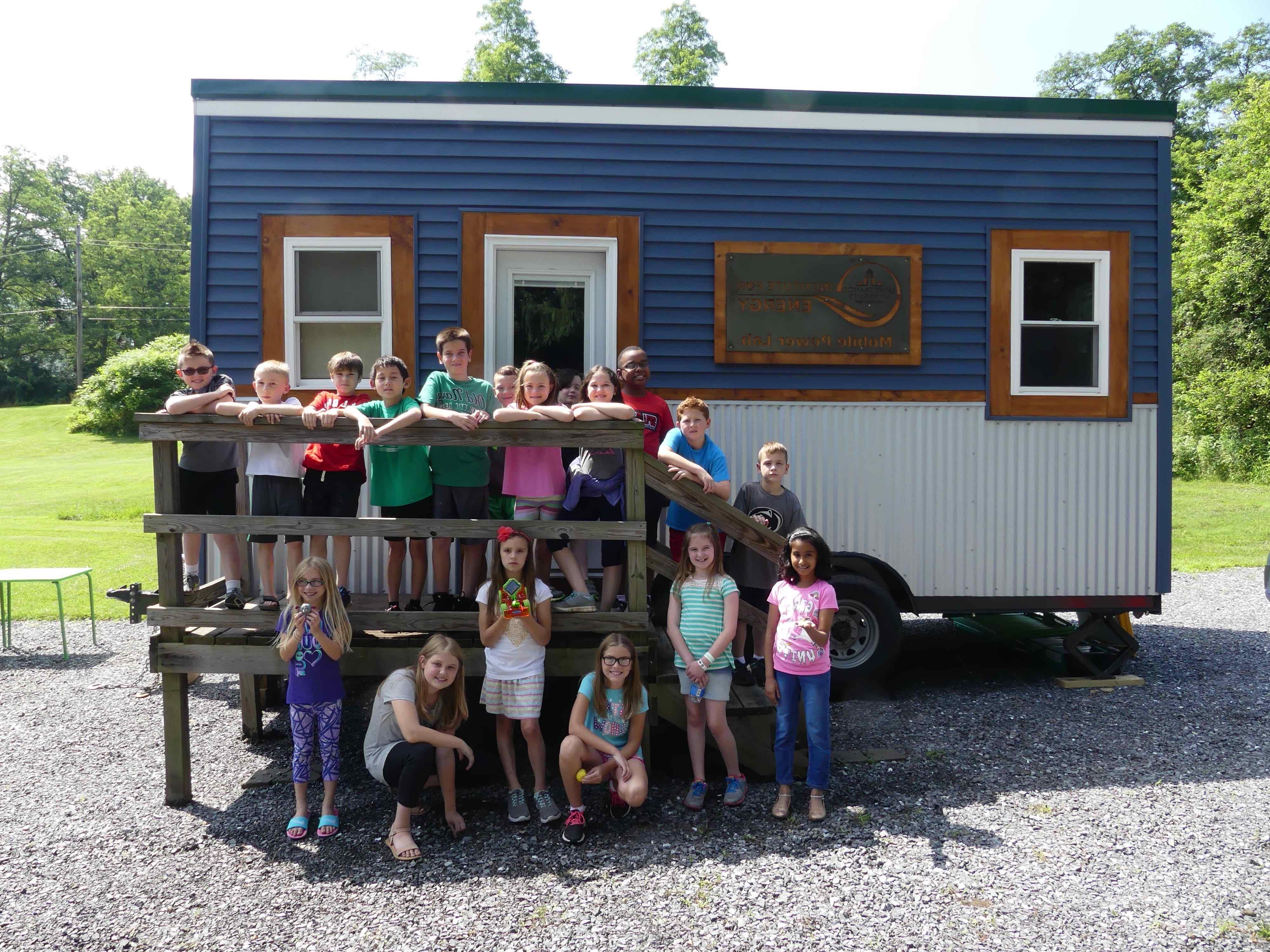 summer camp students posing in front of Tiny House classroom at SFU